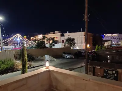 a view of a parking lot at night at bedroom (3) apartment of 200 square meters with an outdoor terrace in Umm Uthainah