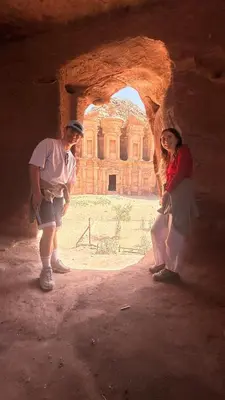a man and a woman standing in a cave at Issa Snaffi Bedouin home in Wadi Musa