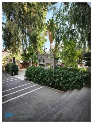 a row of hedges in a parking lot at Weibdeh Heights Hotel Suites in Amman