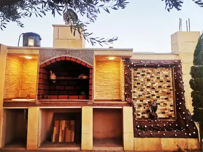 a house with a brick wall and an oven at Top 