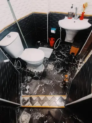a bathroom with a toilet and a sink at Top 