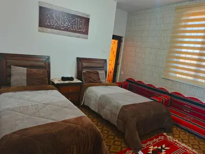 a hotel room with two beds and a window at Top 