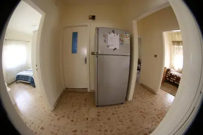 a hallway with a refrigerator in the middle of a room at Alice & Andrew Apt. Few Steps to Madaba Old City Center in Madaba