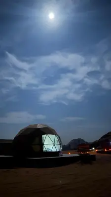 a dome tent on the beach at night at Wadi Rum Aviva camp in Wadi Rum