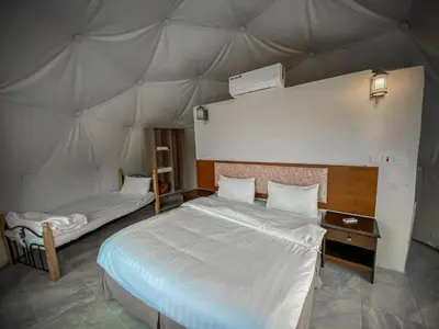 a bedroom with two beds in a tent at Wadi Rum Aviva camp in Wadi Rum