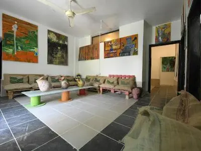 a living room with couches and tables in a room at St.Jadoor Inn in Al Azraq ash Shamālī