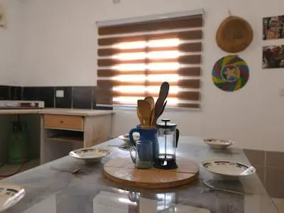 a kitchen with a table with a jar and utensils at St.Jadoor Inn in Al Azraq ash Shamālī