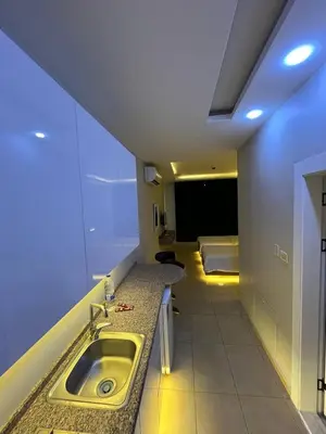 a bathroom with a sink in a room at 7 Days Hotel in Umm Uthainah