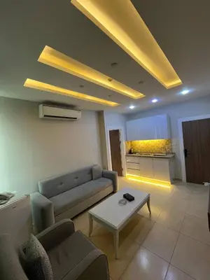 a living room with a couch and a table at 7 Days Hotel in Umm Uthainah