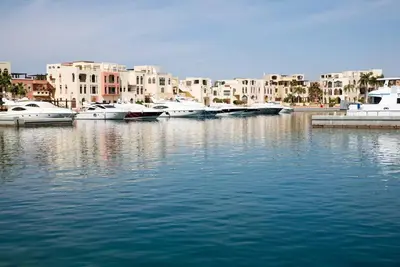 a group of boats docked in a harbor with buildings at Maria Beach Ground Floor Apartament in Aqaba
