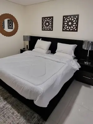 a bedroom with a large bed with white sheets and pillows at Byblos Prime in Aqaba