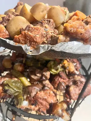 a basket of food with chicken and vegetables on it at Scarlet Luxury Camp Wadi Rum in Wadi Rum