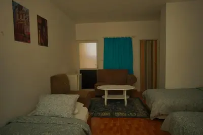 a living room with a couch and a table at Petra Main Gate Studios in Wadi Musa