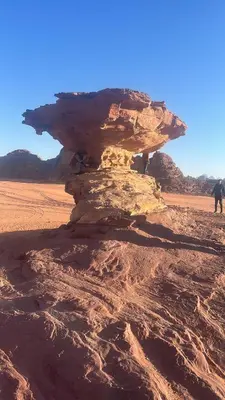 a rock formation in the middle of a desert at Nara Wadi RUM Camp in Wadi Rum
