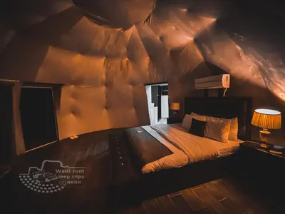 a bedroom with a bed in a tent at Rum Kingdom Camp in Wadi Rum
