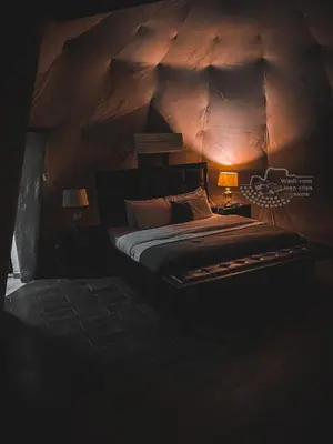 a bedroom with a large bed with a wooden ceiling at Rum Kingdom Camp in Wadi Rum