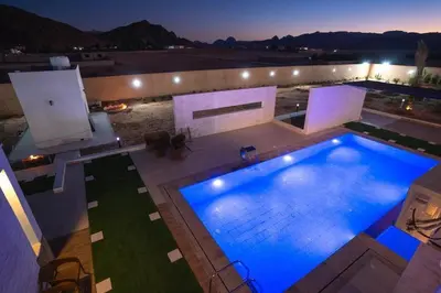 an overhead view of a swimming pool at night at مزرعة وفيلا الريان وادي رم in Ruʼaysat al Khālidī