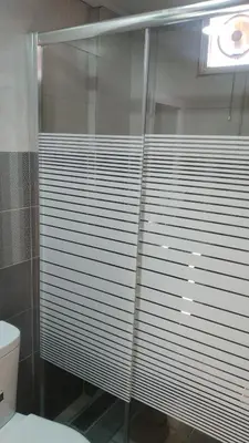 a glass shower in a bathroom with a toilet at Petra Inn House in Wadi Musa