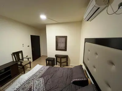 a bedroom with a bed and a table and chairs at Horizon22 in Wadi Musa