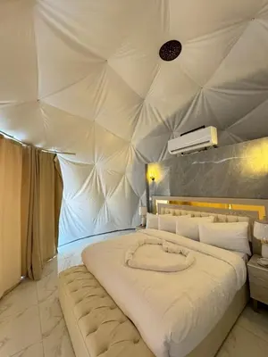 a bedroom with a large bed in a tent at Anwar Al Qamar Luxury Hotel in Wadi Rum