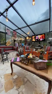 a living room with a roof with a table at بيت الطبيعة nature house in Jerash