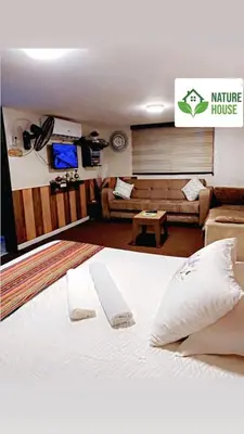 a bedroom with a bed and a living room at بيت الطبيعة nature house in Jerash
