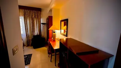 a hotel room with a desk and a chair at Tell Madaba in Madaba
