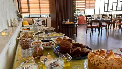 a table with many different types of bread and pastries at Tell Madaba in Madaba