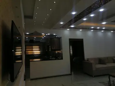 a living room with a couch and a kitchen at Petra Guests home in Wadi Musa
