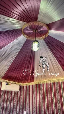 a stage with purple curtains and a chandelier at Wadi Rum Space camp in Wadi Rum