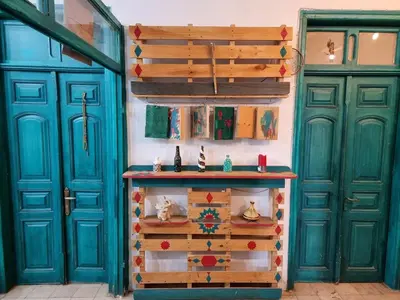 a room with two blue doors and a table at Shams House in Amman