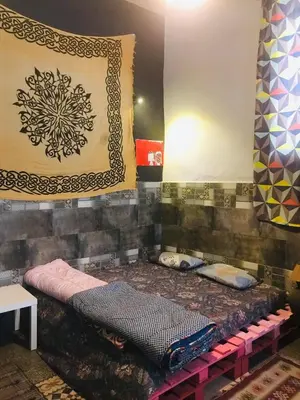 a room with a bed in the corner of a room at Shams House in Amman