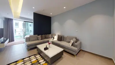 a living room with two couches and a table at Al Fares Luxury furnished Apartment-Damac Tower in Amman