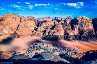 an aerial view of a mountain range with buildings at Mad Mix camp in Wadi Rum