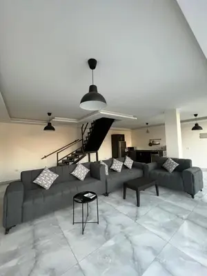 a living room with a couch and a table at Aroma Mountain Dead Sea in Sowayma