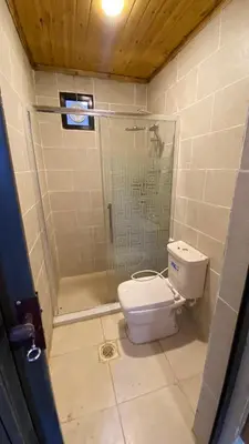 a bathroom with a shower and a toilet at Desert Jewel Camp in Wadi Rum