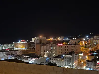 a view of a city at night with lights at Petra luxurious view house in Wadi Musa