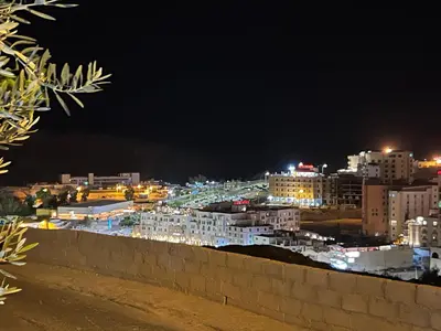 a view of a city at night at Petra luxurious view house in Wadi Musa