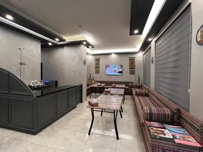 a restaurant with tables and a counter in a room at Sandra Hotel in Amman