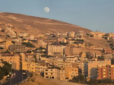 a city on a hill with buildings on it at Petraone in Wadi Musa