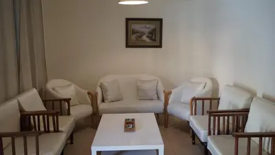 a waiting room with chairs and a table at Ground floor apartment by circular pool for families only in Talabay in Aqaba