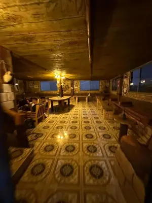 an overhead view of a room with a table and benches at Dana Nabil Ecu Camp House - Main Gate Dana nature reserve in Dana