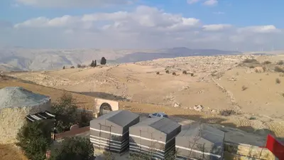 an aerial view of a building in the middle of a desert at Dana Nabil Ecu Camp House - Main Gate Dana nature reserve in Dana