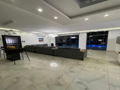 a large living room with a couch and a table at Aroma Chalet in Sowayma
