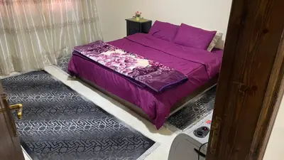 a bedroom with a purple bed with purple pillows at شقه فندقيه.Apartment,Petra in Wadi Musa