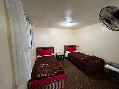a room with two beds and a window at شقة سيلا in Irbid