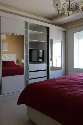 a bedroom with a bed and a tv in a room at Ritala Royal Residence in Amman