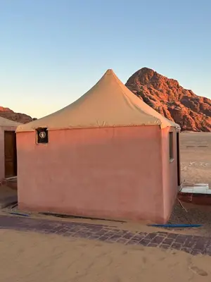 a tent in the desert with a mountain in the background at Rum Luxury Camp in Wadi Rum