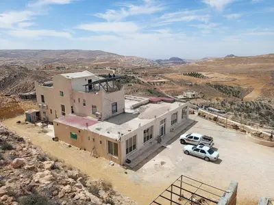 an aerial view of a building in the desert at Petra Mountain House in Wadi Musa