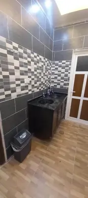 a bathroom with a sink and a trash can at Petra Mountain House in Wadi Musa
